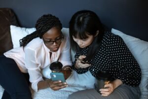 photograph of friends looking at a cell phone