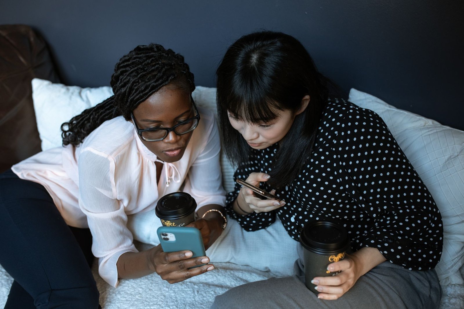 photograph of friends looking at a cell phone